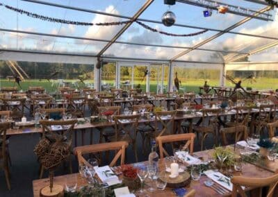 Marquees.Com | Pagoda and Sky Lounge Marquee Hire Cheshire and North West | Clearspan marquee interior with rustic tables and chairs