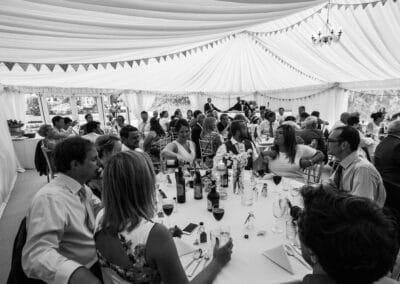 Marquees.Com | Temporary warehouse and long term marquee hire Cheshire and North West | Round wedding tables and guests black and white image